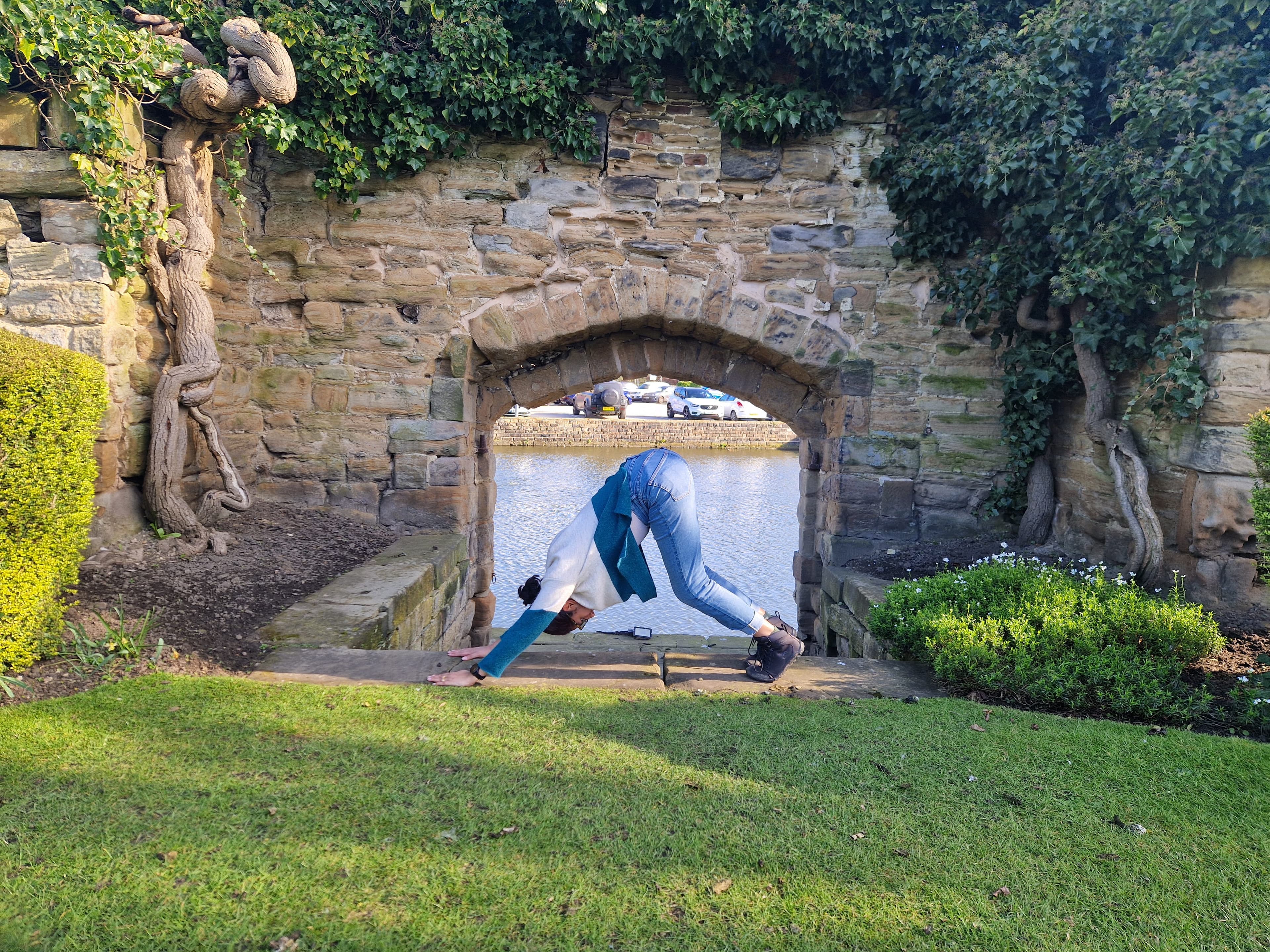 Shruti demonstrating Downward Facing Dog pose